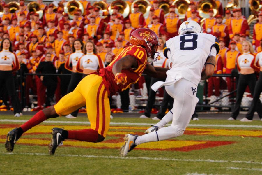 Iowa State defensive back Brian Peavy attempts to tackle West Virginia wide receiver Marcus Simms as he falls into the end zone for a touchdown on Nov. 26 at Jack Trice Stadium. West Virginia led Iowa State 21-16 at halftime.