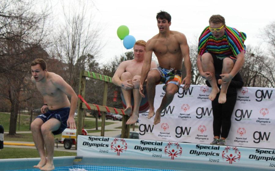 Four fraternity brothers jump into the ice cold water during the Polar Plunge to benefit the Special Olympics outside of the Memorial Union on April 1. The Greek community together raised nearly $356,000 by the time the plunge started. 