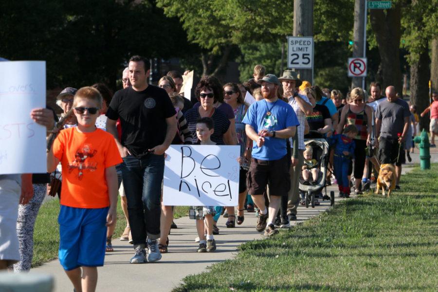 Marchers walk south down Duff Ave. during the Ames Stands Together Opposing White Nationalism event Sunday, Aug. 13. Several children were in attendance, some of them holding signs of their own. 