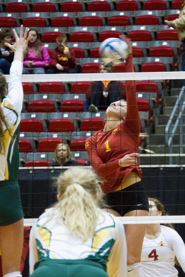 Sophomore Hannah Bailey hits the ball over the net in a game against North Dakota State University in the Cyclones first round of the spring tournament. The Cyclones would go on to beat NDSU 2-0, and go 3-0-1 in the tournament. 