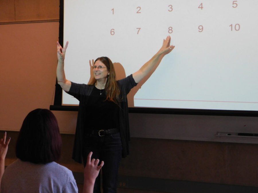 Lecturer Sandra Bucholz teaches counting in American Sign Language in Coover Hall.