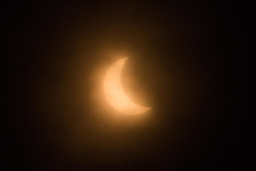 The 2017 Solar Eclipse made a brief appearance on the Iowa State University campus, seen here through the clouds. 