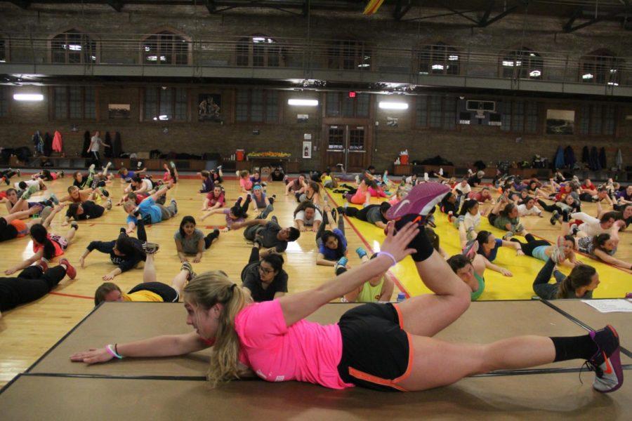 Insanity Instructor Paige Perkins shows the group a core workout at the Insanity LIVE! Launch Party at East State Gym on Jan. 12. 