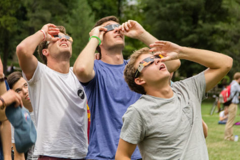 Iowa State Students Sam Pickett, Trevor Jensen and Joe Anderson view the 2017 solar eclipse though special glasses Aug. 21 during the brief moments it was visible though the clouds.
