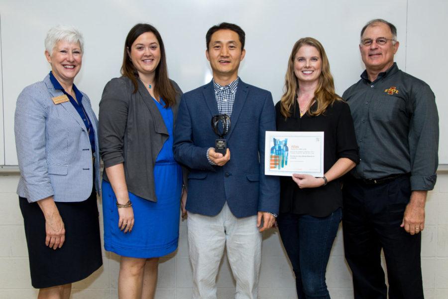 DC Lee (center) and Angelique Brellenthin (second right) are presented their award by Elseviers Heather Luciano (second left). Dean Laura Jolly (left) and kinesiology chair Phil Martin (right) also joined the presentation.