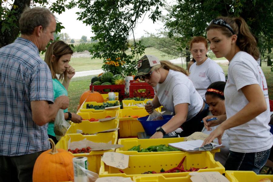 Iowa State horticulture students work the farmers market. All the produce that was sold came from the station.