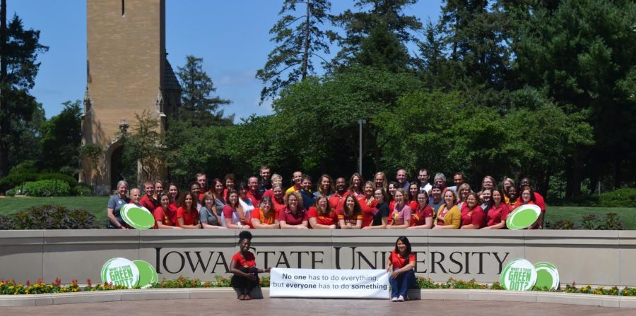Faculty and staff who participated in the first round of facilitator training of the Green Dot program pose by the Iowa State University sign.