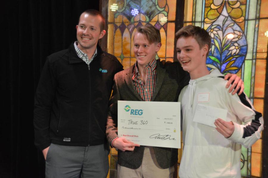Chris James (middle) and John Clark (right) accept their $1000 reward after winning overall best pitch at the Innovation Pitch event held in the M-Shop March 8, 2017. James and Clark, both freshmen in pre-business, pitched the idea of their product, called Truth 360. The idea behind Truth 360 is to install 360 degree cameras into zoo exhibits and aquarium tanks, sending the camera footage to virtual reality headsets. People can then wear the headsets and experience it as if they were up-close with the animals. 