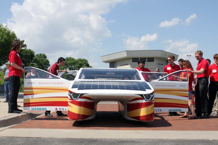 Members of PrISUm solar car team around their newly unveiled car, Penumbra, outside of the Alumni Center on June 2.