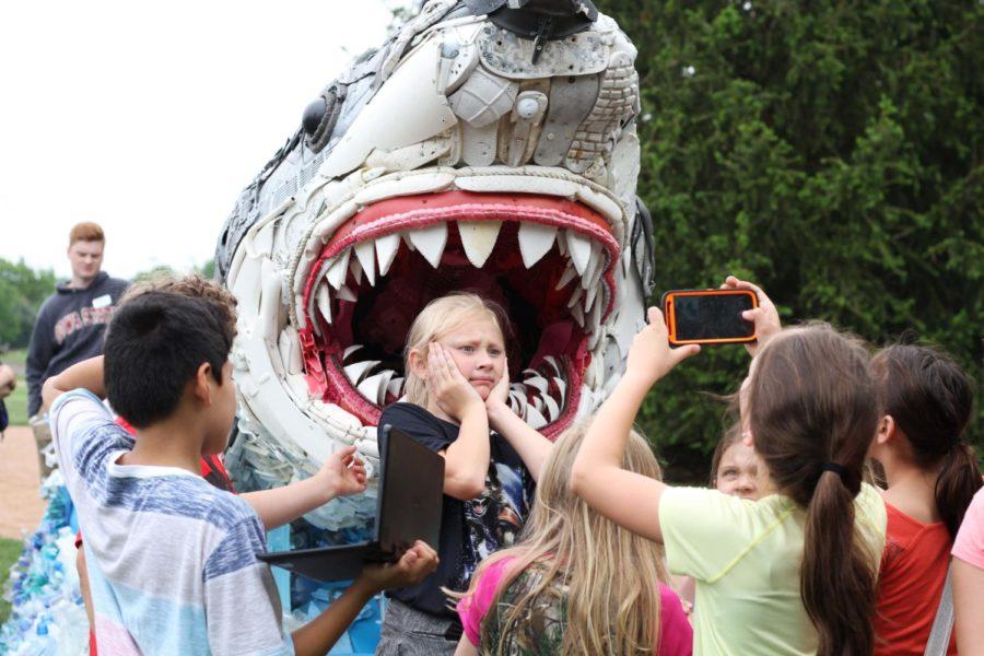 Third graders pose for pictures in front of a sculpture of a Great White shark as part of the Washed Ashore exhibit at Reiman Gardens on May 17. The exhibit provides an opportunity to speak to children about pollution and our impact on the world in a fun and interactive way. 