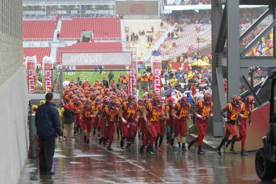 Members of the Iowa State football team leave the field after warmups. The game against Kansas was delayed due to weather conditions.