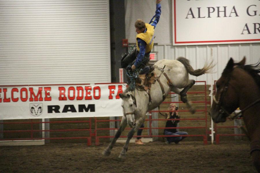 A cowboy holds on while on the back of a bucking horse during the 55th Annual Cyclone Stampede Rodeo.