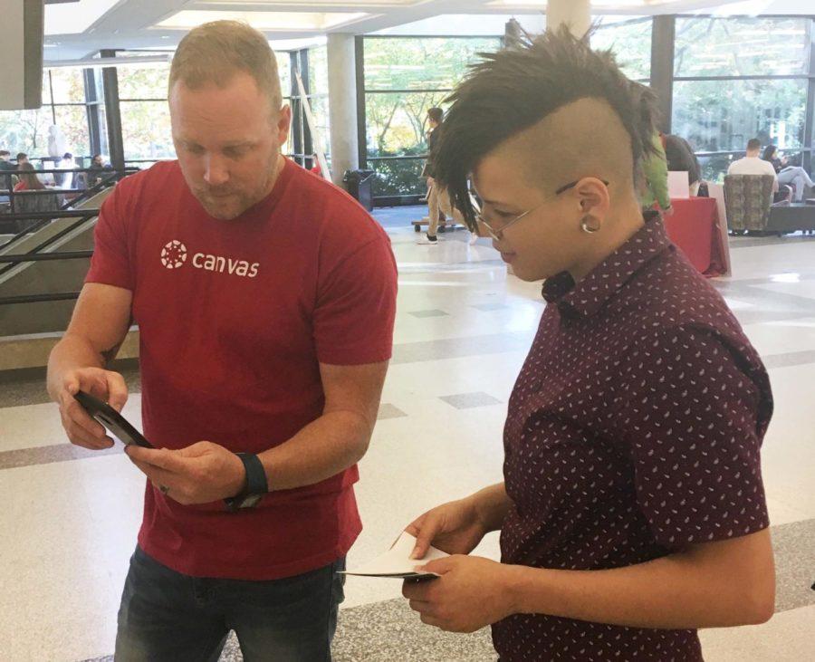 Ryan Jacobson, strategic customer success manager of Canvas demonstrated some Canvas functions to an undergraduate student at Canvas Countdown Parks Library event.
