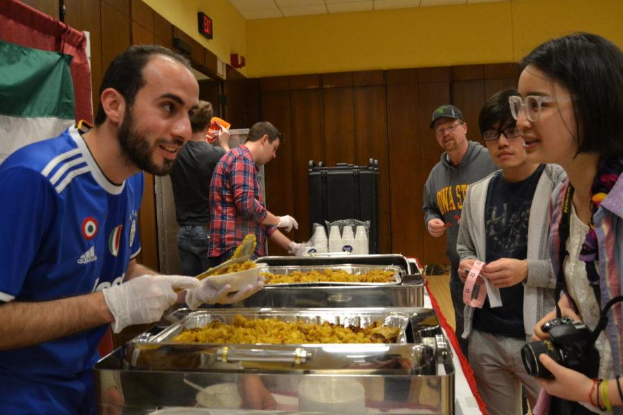 Arab Student Association President, Mohamed Abufalgha, serves people kabsa during the Internaitonal Food Fair in the Memorial Union April 9. The event is put on by various international student clubs and organizations.