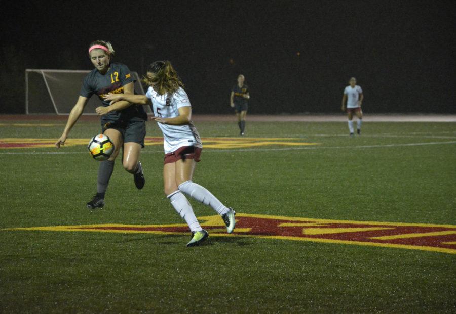 Kasey Opfer, midfielder, tries to control the ball during the Cyclones versus Oklahoma game at the Cyclone Sports Complex on Oct. 6. After playing in on and off rain showers the game ended 0-0 in double overtime.