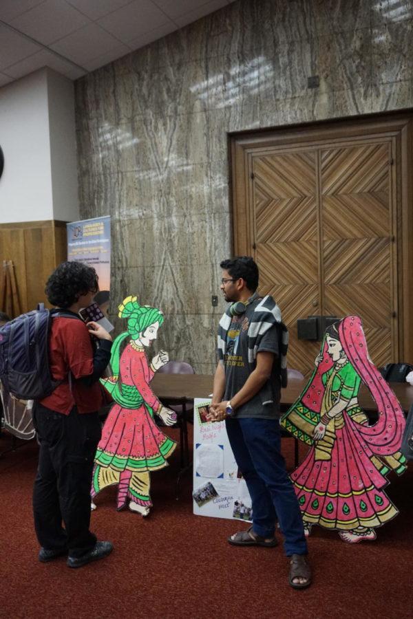 A representative from the Indian Students Association speaks with a student about what it means to be in their association.