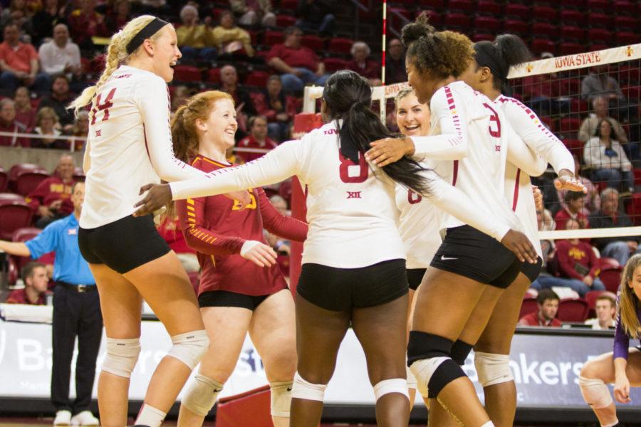 Members of the ISU volleyball team celebrate after scoring a point during the first set of the Kansas State Volleyball Match. Iowa State Defeated K-State in three consecutive sets.