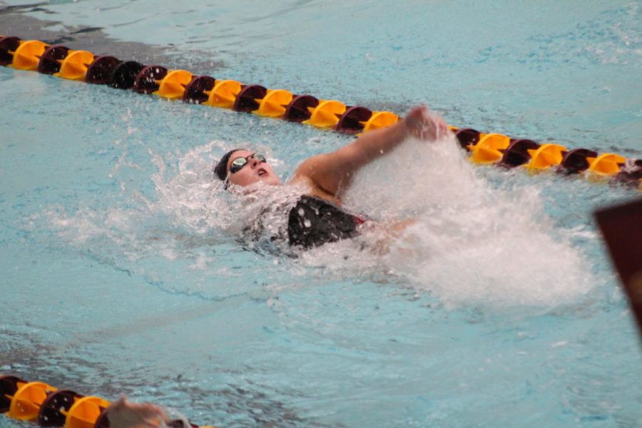 A member of the Iowa State Women's Swimming team swims backstroke during the team's meet against Omaha in the Beyer Hall pool on Oct. 27. 