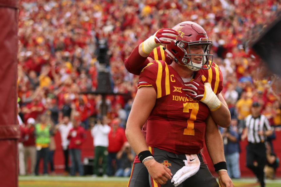 Iowa State quarterback Joel Lanning is embraced by a member of the Iowa State offensive line after scoring in the first half against Baylor.