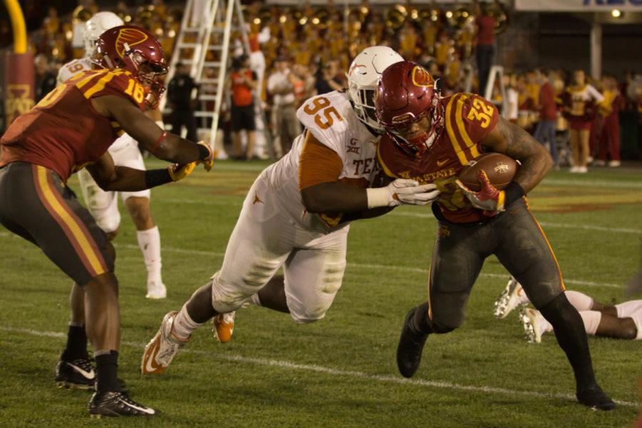 David Montgomery pushes past defenders and continues up the sideline during the Iowa State vs Texas Football game. Longhorns won 17-7. 