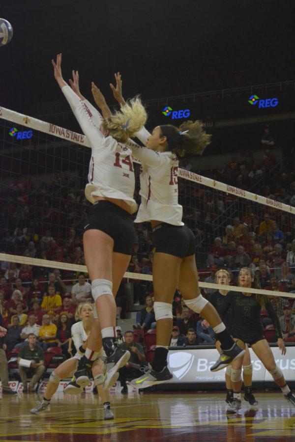 Jess Schaben, outside hitter, and Avery Rhodes, middle blocker, attempt to hit the volleyball back to the Baylor Bears during their game on Oct. 4 at Hilton Coliseum. The Cyclones lost 0-3.