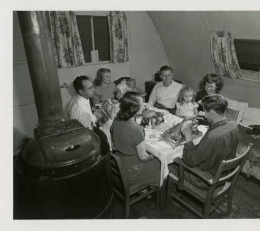 Thanksgiving Dinner in one of the quonset huts in Pammel Court, 1948. Quonset huts housed two families.