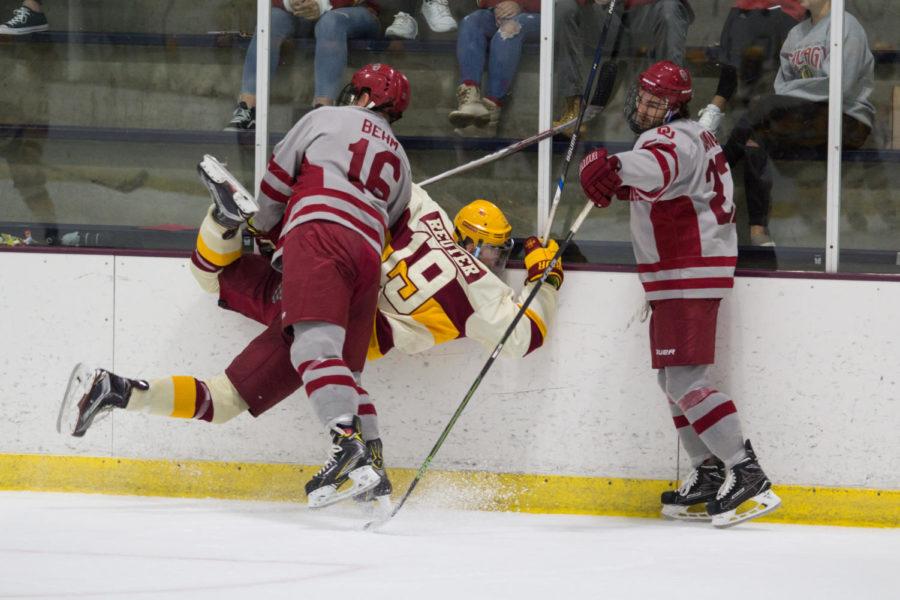 Cyclone Hockeys Kody Reuter gets checked into the wall during the game against Oklahoma Oct. 6. The Cyclones defeated Oklahoma 3-1.