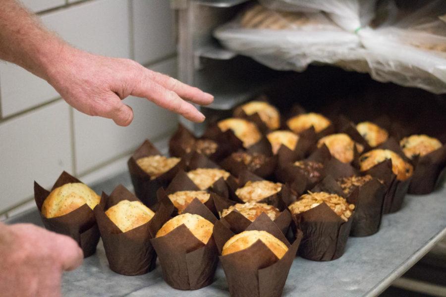 Mark Weber, bakery manager at Knapp-Storms Commissary, checks muffins before being loaded onto a transport cart. 