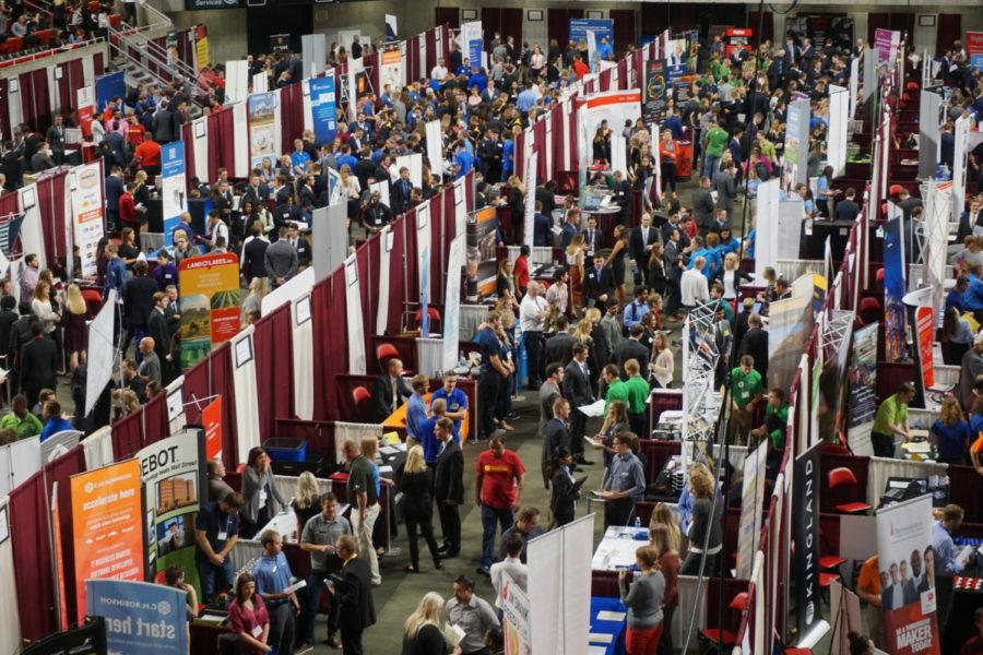 Students explore the different booths on the floor of Hilton Coliseum for the Business career fair. 