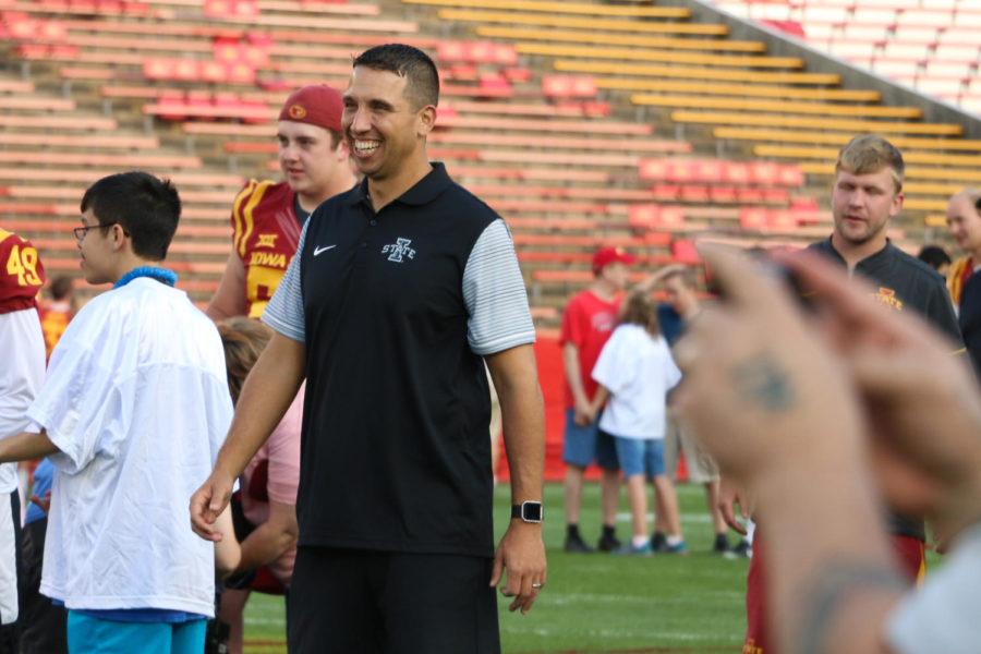 Head football coach Matt Campbell smiles as he watches his players participate in the touchdown drill during Victory Day on Aug. 25. Victory Day gives children with disabilities the opportunity to meet and participate in drills with Cyclone football players.