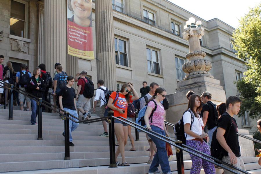 Students walk in and out of Curtiss Hall using the front steps during the first day of classes of the 2013 fall semester.