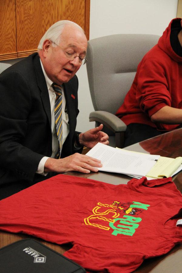 Senior Vice President for Business and Finance, Warren Madden look at a Norml ISU t-shirt. The shirt is having some controversy due to the logo of ISU mascot Cy, being used since the use of marijuana is illegal. The clubs goal is to promote change.