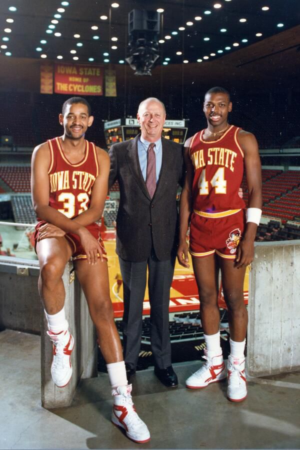 Sam Hill, Johnny Orr, and Jeff Grayer pose for a picture in Hilton Coliseum.