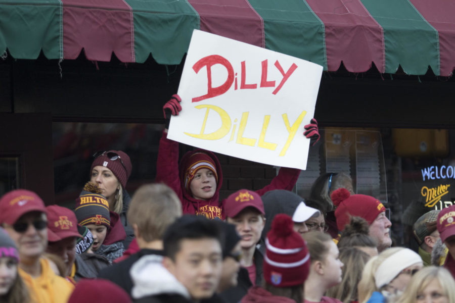An+Iowa+State+fan+holds+a+sign+during+the+AutoZone+Liberty+Bowl+Parade+in+Memphis.