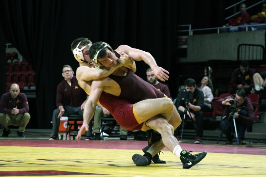 Colston DiBlasi wrestles Minnesotas Jake Short on Feb. 19 in Hilton Coliseum. Short came up with a 9-1 major decision over DiBlasi. Minnesota defeated Iowa State 40-7 in their final meet at home this season.