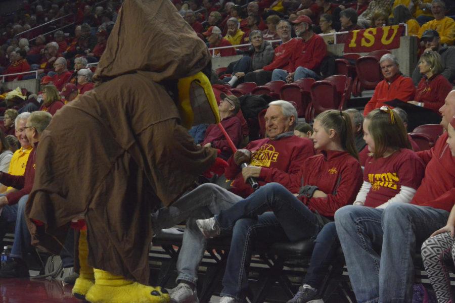 Cy, dressed as a jedi, fights over a lightsaber with an audience member during the womens basketball game against North Carolina Central on Dec. 10 at Hilton Coliseum.