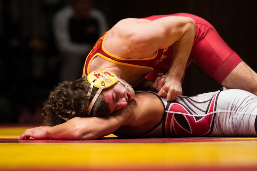 Redshirt sophomore Chase Straw wrestles Bryant Clagon Nov. 26 in Stephens Auditorium during the Cyclones meet against Rider. The Cyclones were defeated 15-22. 