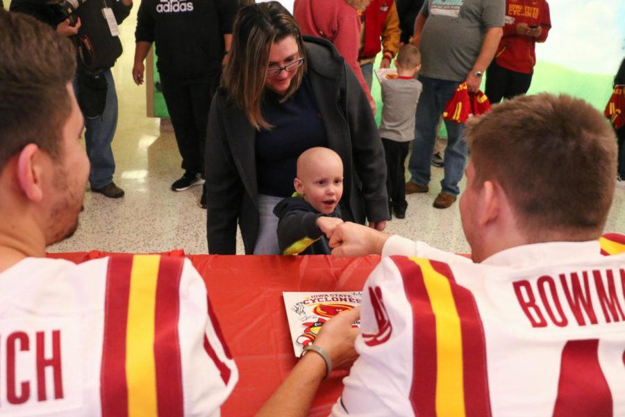 Liam, 3, fist bumps linebacker Jason Bowman (right) during a meet and greet at St. Jude Childrens Research Hospital in Memphis, Tennessee on Dec. 28.