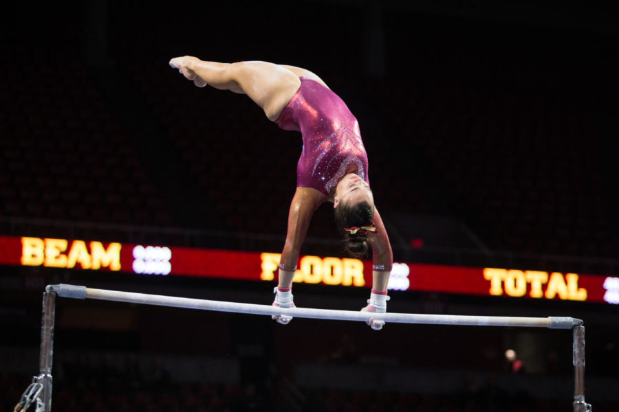 Junior MJ Johnson works to correct a handstand in her uneven bars routine during the first home meet of the season against Arizona Jan. 12.  Johnson scored a 9.625.