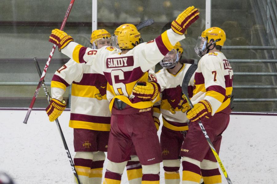 Members of the Cyclone Hockey team celebrate after their first and only goal by senior Kody Reuter Dec. 3 at the Ames Ice Arena during their game against Minot State