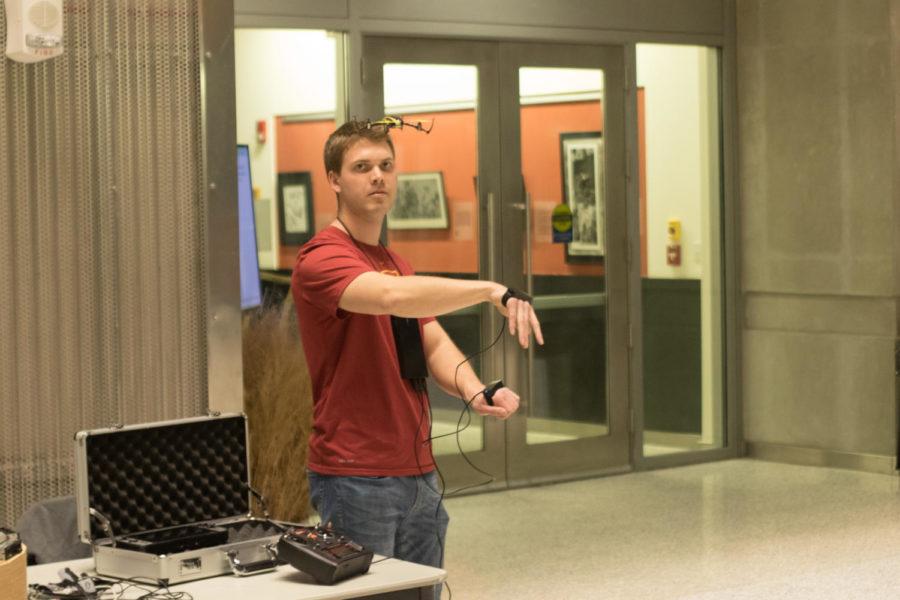 Iowa State student Tim Lindquist demos the motion-controlled drone that he and fellow student Jakub Hladik created. The apparatus worn on the hands is the second version of the project, the first iteration consisted of bikers gloves with circuitry attached.