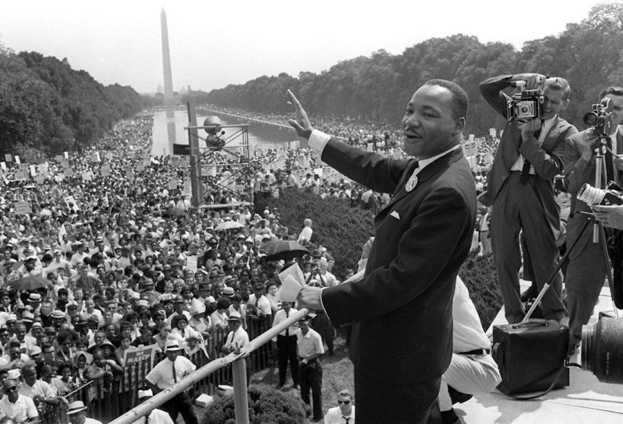 US civil rights leader Martin Luther King Junior waves to supporters from the steps of the Lincoln Memorial on August 28, 1963 on the Mall in Washington DC during the March on Washington. 