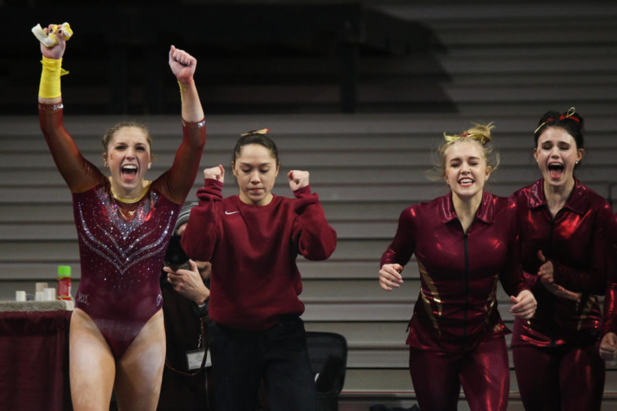 From left, Laura Burns, Briana Ledesma, Emily White and Molly Russ cheer after teammate Meaghan Sievers uneven bars routine during their meet against Arizona on Jan. 12, 2018. The Cyclones beat the Wildcats 195.45 to 194.975.