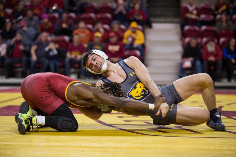 Redshirt Sophomore Markus Simmons wrestles against Northern Colorado wrestler Rico Montoya Jan. 5 in Hilton Coliseum.  The cyclones were narrowly defeated by the UNC Bears 20-22. 