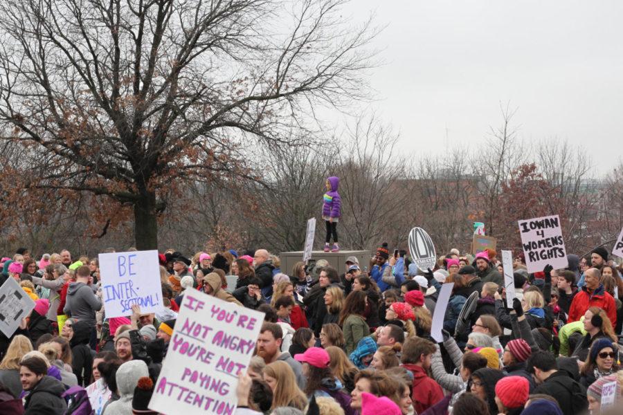 A+girl+stands+above+the+crowd+of+marchers+during+the+Womens+March+on+the+Iowa+State+Capitol+on+Jan.+21.