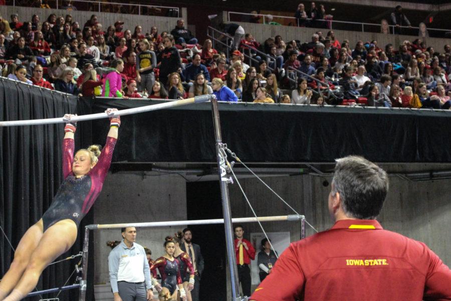 Head coach Jay Ronayne watches Haylee Young perform her uneven bars routine Jan. 27.