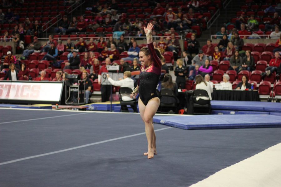 Kelsey Paz smiles during her floor routine Jan. 13 in Hilton Coliseum. Paz finished 1st all-around with a 38.975 during a tri-meet against Towson and UW-Oskosh. Iowa State won the meet with a score of 194.275.