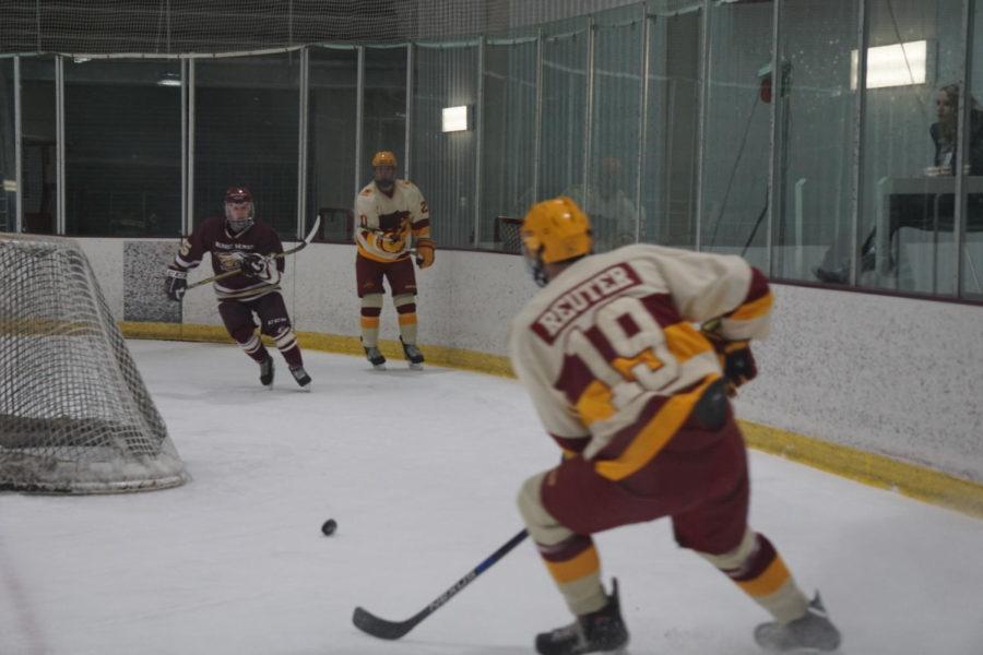 Senior Kody Reuter is seen here receiving a pass from his team mate at the Iowa State VS Rob Morris hockey game on January 19th. This was one of many passes that moved the puck away from a close goal against Iowa State.