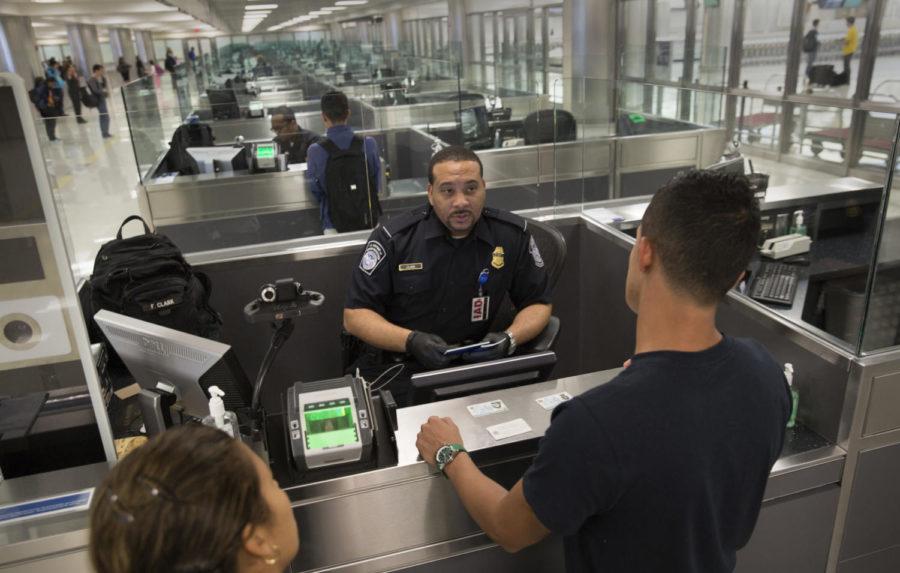 U.S. Customs and Border Protection officers screen international passengers.