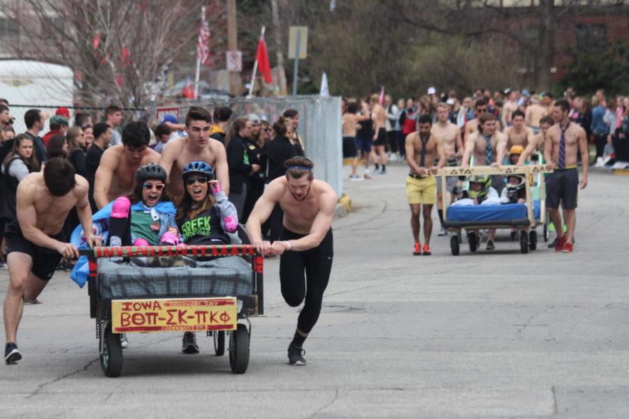 Bed race contestants compete to be the fastest bed during the Greek Olympics April 1. The fraternity members push the beds all the way around sorority circle hoping to get first place.